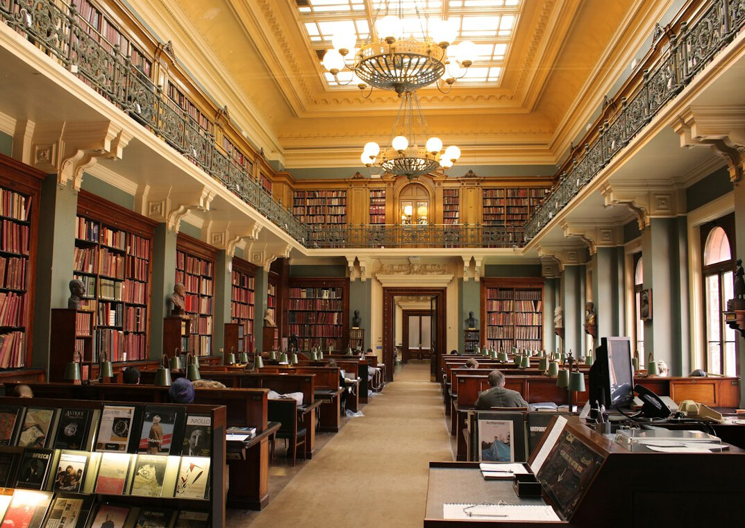 Old library archive with tall wooden bookshelves